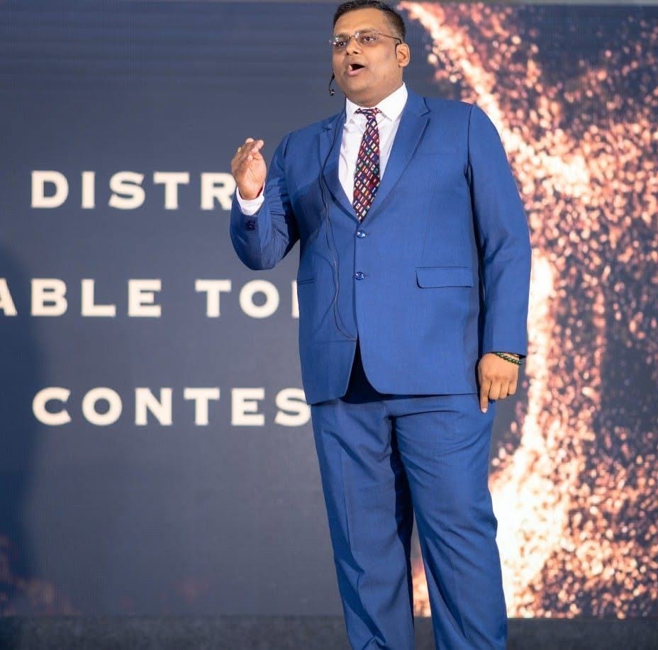 Harsh Singhal speaking on stage at the District Table Topics Contest
